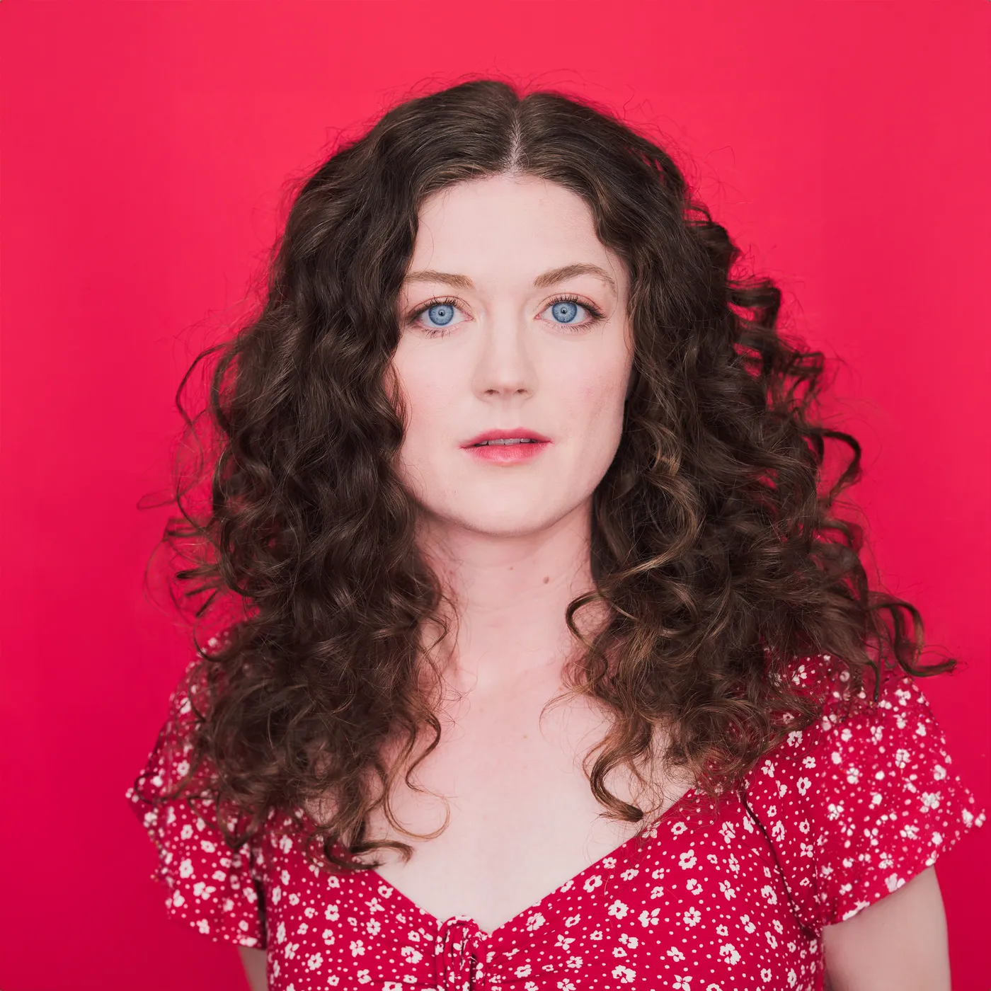 Portrait of Krystina Whalen against a red background